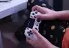 person holding white sony ps 4 controller